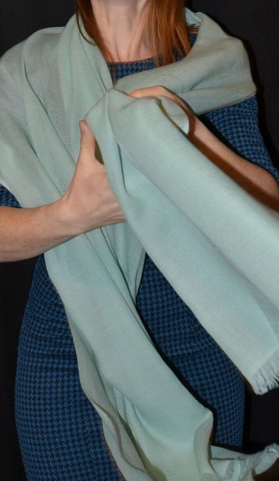 Empar is wearing a seafoam blue ultra-light diamond weave Pumori shawl, 100% pashmina